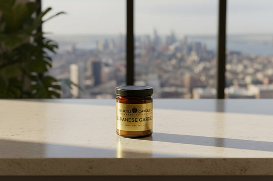 Jar of Japanese garden candle on a table with a cityscape view in the background